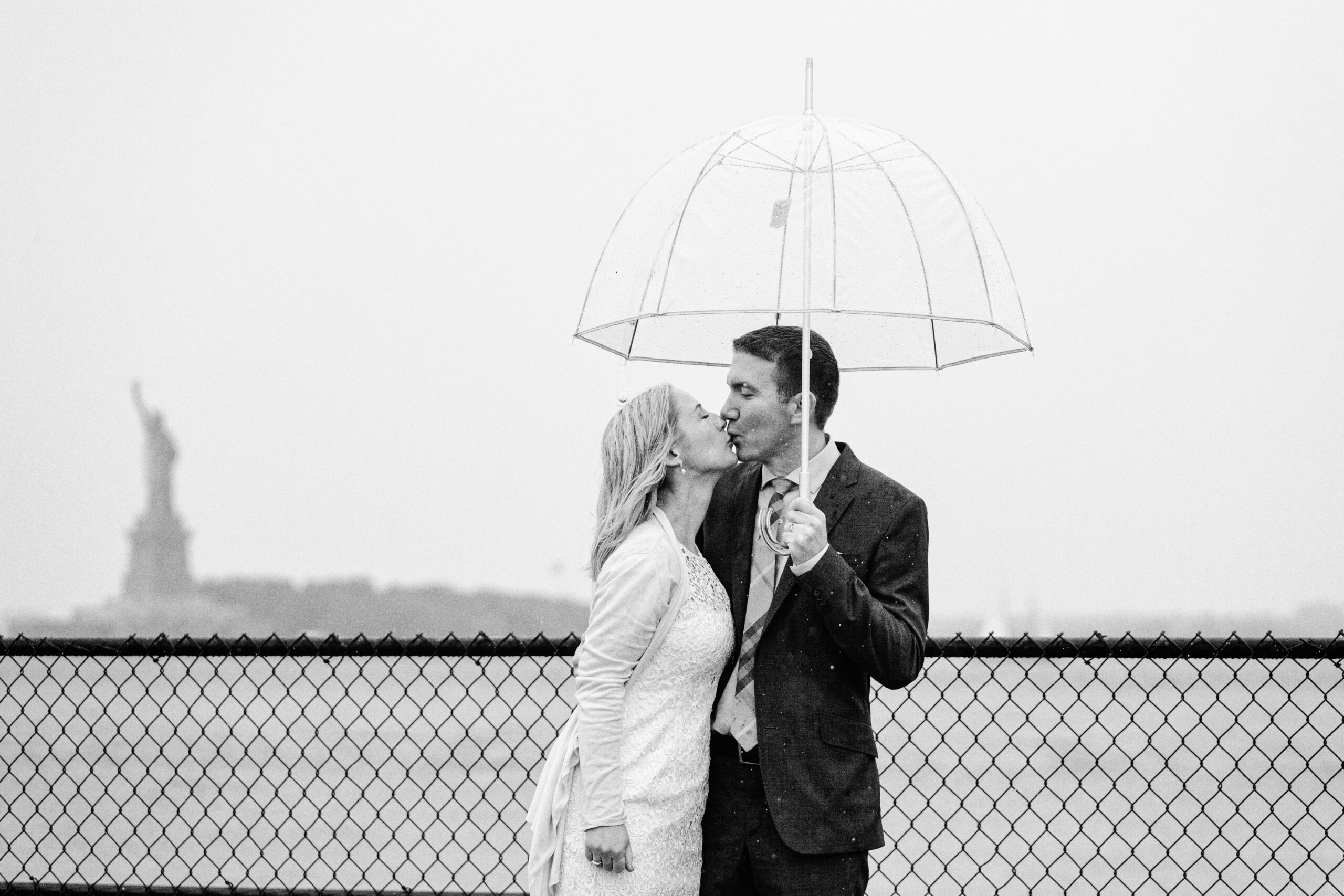Wedding day kiss with the Statue of Liberty in the Background