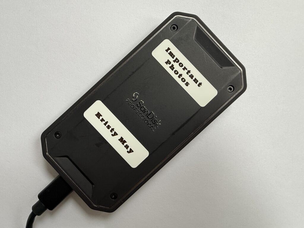 A Sandisk 1TB solid state hard drive labeled with "Important Photos"